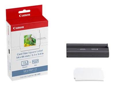 Canon SELPHY Kartengröße quadratisches Etikettenpapier Schachtel und ein schwarzer kompakter Fotodrucker auf weißem Hintergrund, mit einem Stapel von leeren Etiketten davor.