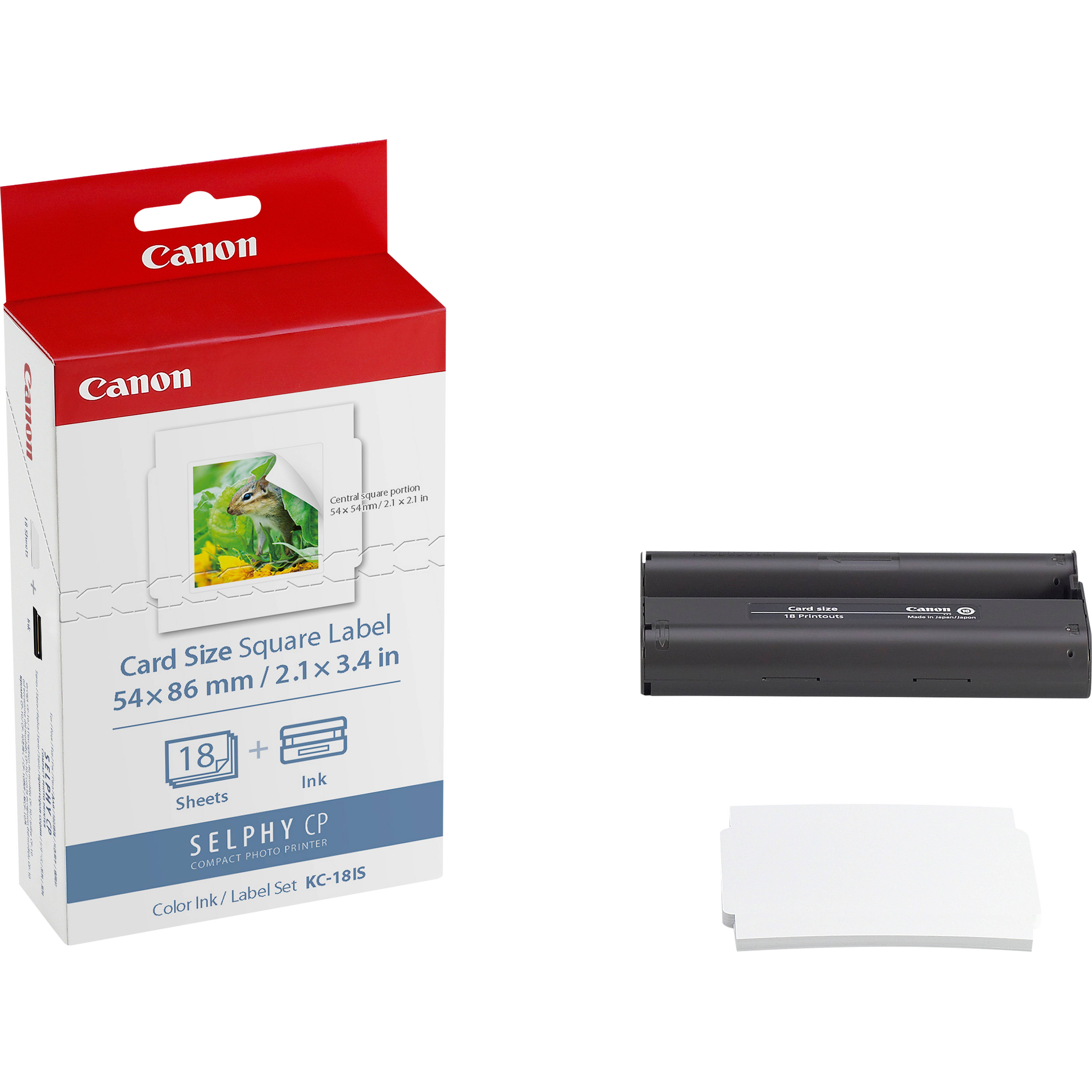 Canon SELPHY CP Kartengröße quadratisches Etikettenpapier-Box, eine schwarze Tintenpatrone und ein Stapel weißer Etiketten auf weißem Hintergrund.
