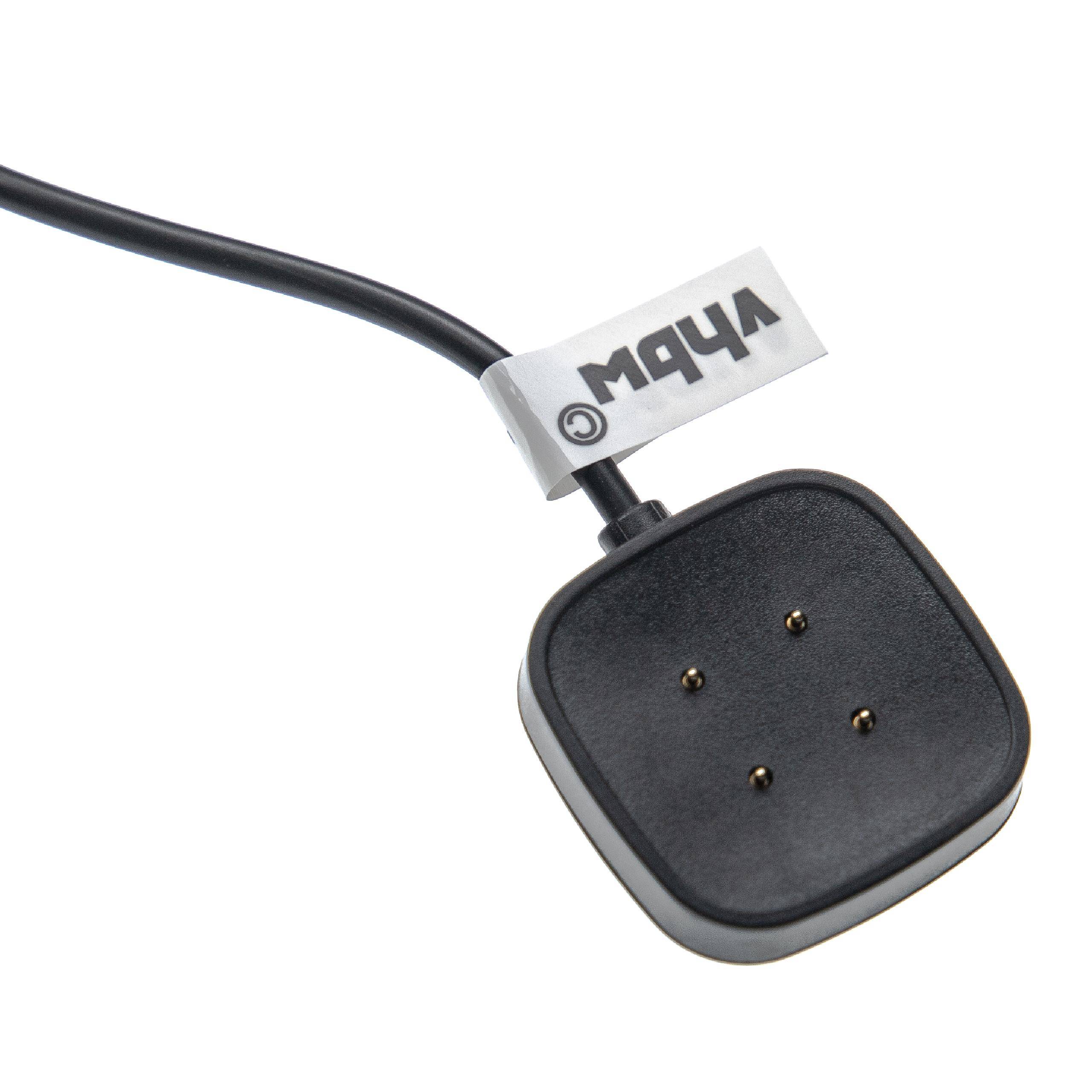 Schwarzer drahtgebundener quadratischer Sensor oder Fernbedienung mit vier Metallkontakten und einem kleinen Etikett auf weißem Hintergrund.