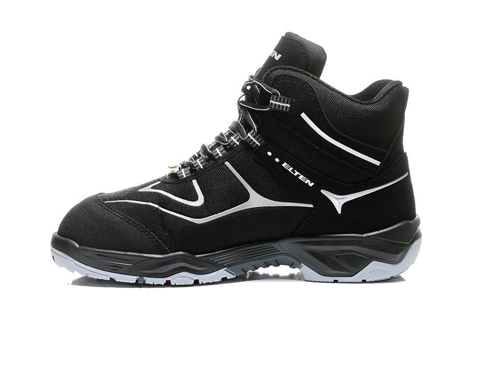 Schwarzer Wanderschuh mit grauen und weißen Akzenten, robuste Sohle, knöchelhohe Passform und Schnürverschluss; geeignet für Outdoor-Aktivitäten.