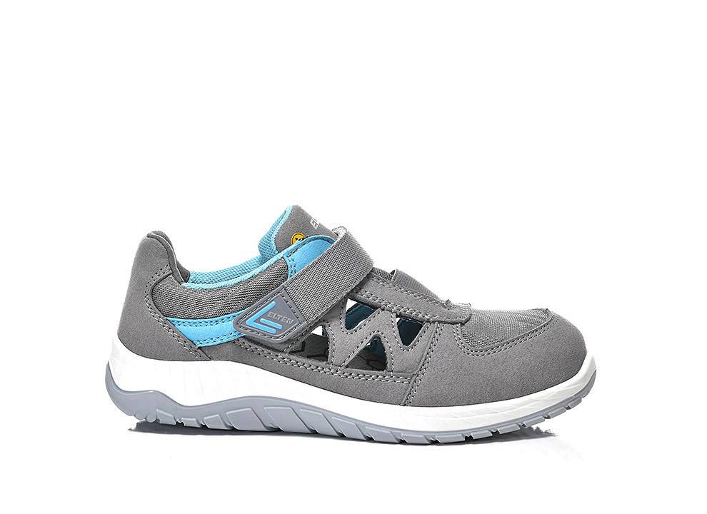 Ein grauer Turnschuh mit türkisfarbener Netzfütterung, ausgeschnittenen Details und einem Klettverschluss. Er verfügt über eine weiße Sohle mit grauen Akzenten.