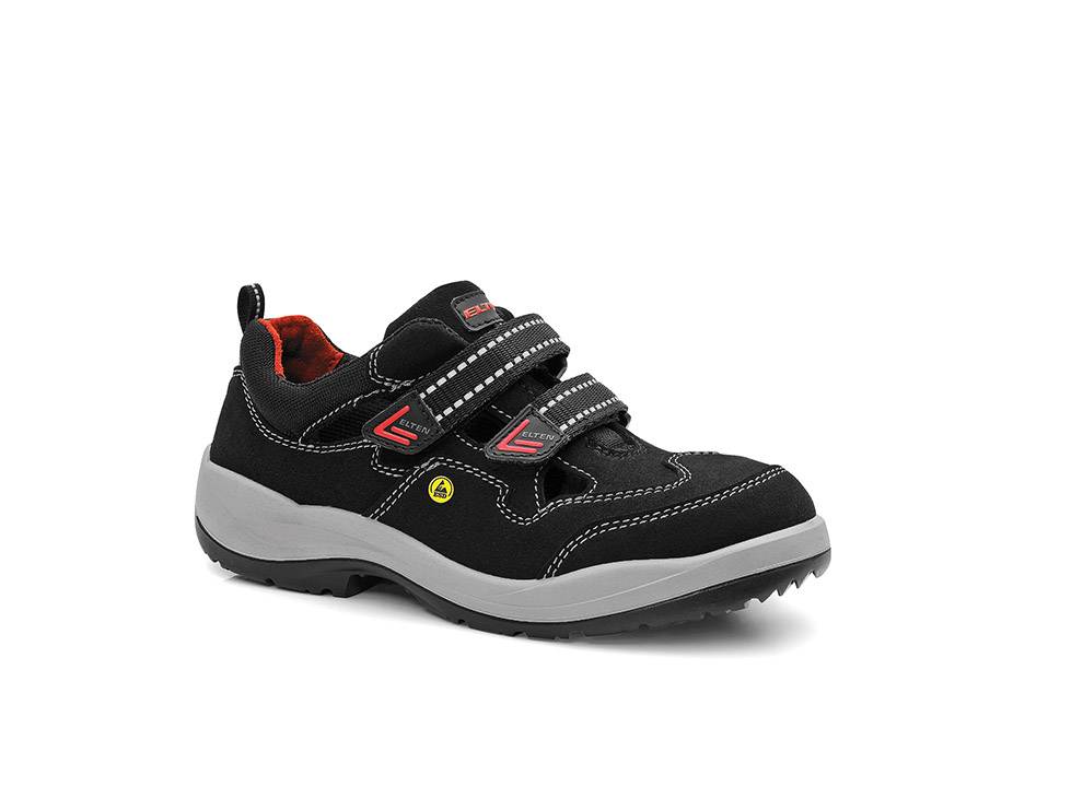 Ein schwarzer und grauer Sneaker mit roten Akzenten und doppelten Klettverschlüssen, entwickelt für Komfort und Halt.