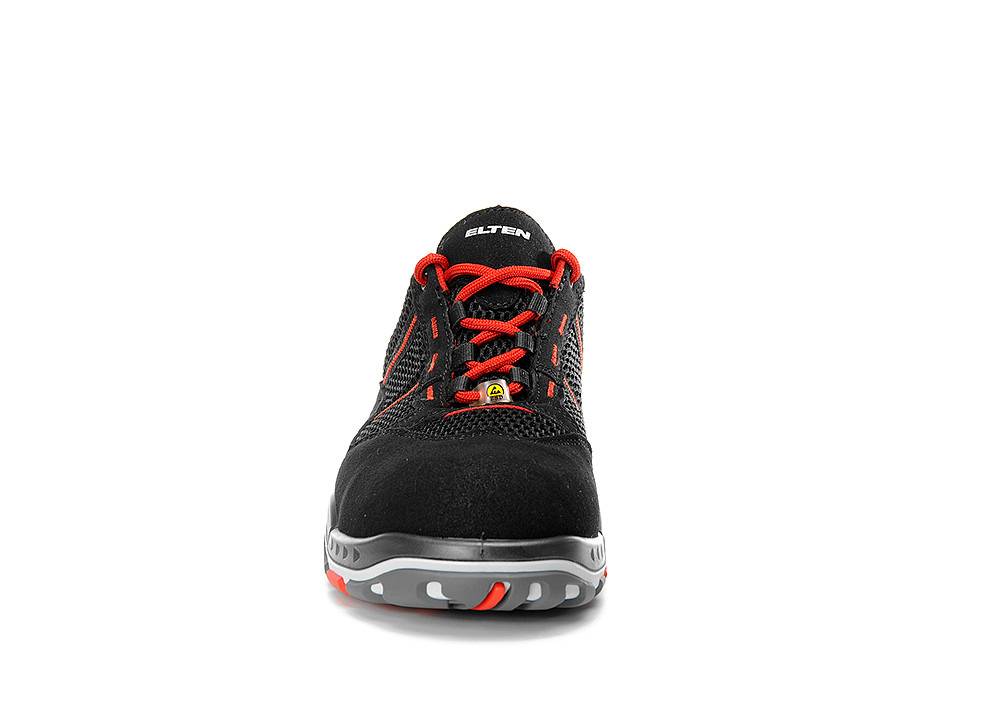 Ein schwarzer und roter Sportschuh mit Mesh-Obermaterial und grauer Sohle, entwickelt für Sicherheit mit verstärkter Zehenpartie. Markenname auf der Zunge.