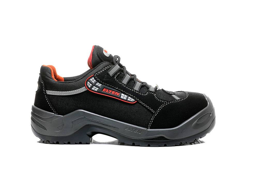 Ein schwarzer und grauer Sicherheitsschuh mit roten Akzenten, ausgestattet mit dickem Profil für rutschfeste Eigenschaften und verstärkter Zehenpartie zum Schutz.