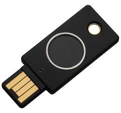 Schwarzer USB-Sicherheitsschlüssel mit Goldstecker und kreisförmiger Berührungsschaltfläche, wird zur Zwei-Faktor-Authentifizierung verwendet.
