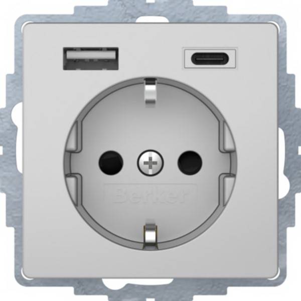 Steckdose mit USB-A und USB-C Ladeanschlüssen über einer runden europäischen Steckdose.
