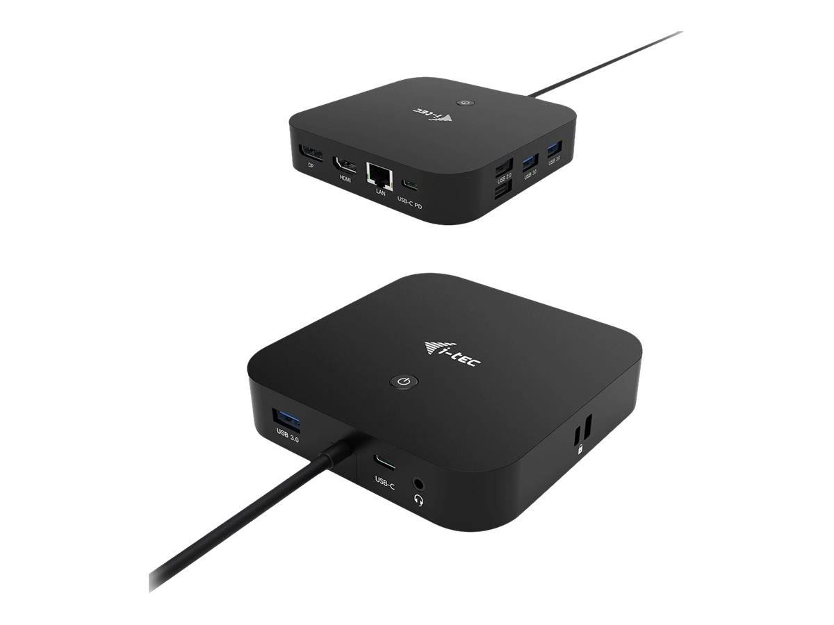 Zwei Ansichten eines kompakten schwarzen Mini-PCs oder Docking-Hubs mit mehreren USB-, HDMI-, Ethernet- und Audiobuchsen, dargestellt mit angeschlossenen Kabeln.