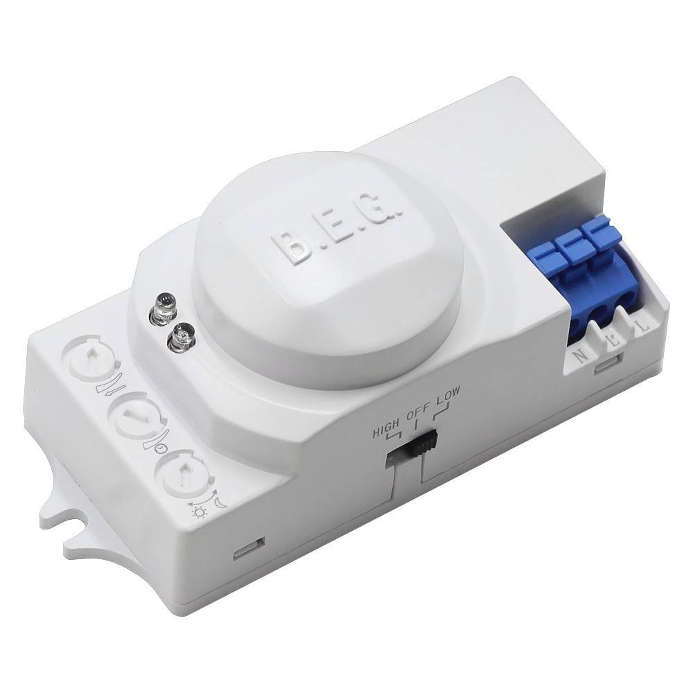 Ein weißes elektronisches Gerät mit einem Ein-Aus-Schalter, einem kreisförmigen Sensor mit der Beschriftung 'B.E.G.', sowie blauen und weißen Anschlussklemmen an der Seite.