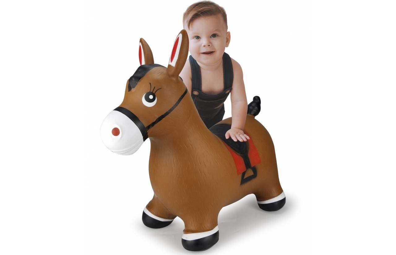 Ein lächelndes Baby sitzt auf einem braunen aufblasbaren Eselspielzeug vor weißem Hintergrund.