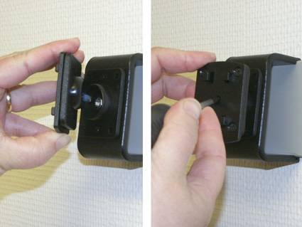 Hände stellen eine schwarze Halterung an einem wandmontierten Gerät ein und zeigen, wie man den Clip befestigt oder sichert.