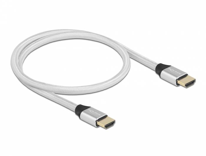 Weiß geflochtenes HDMI-Kabel mit vergoldeten Steckern aufgerollt auf einem einfachen Hintergrund.