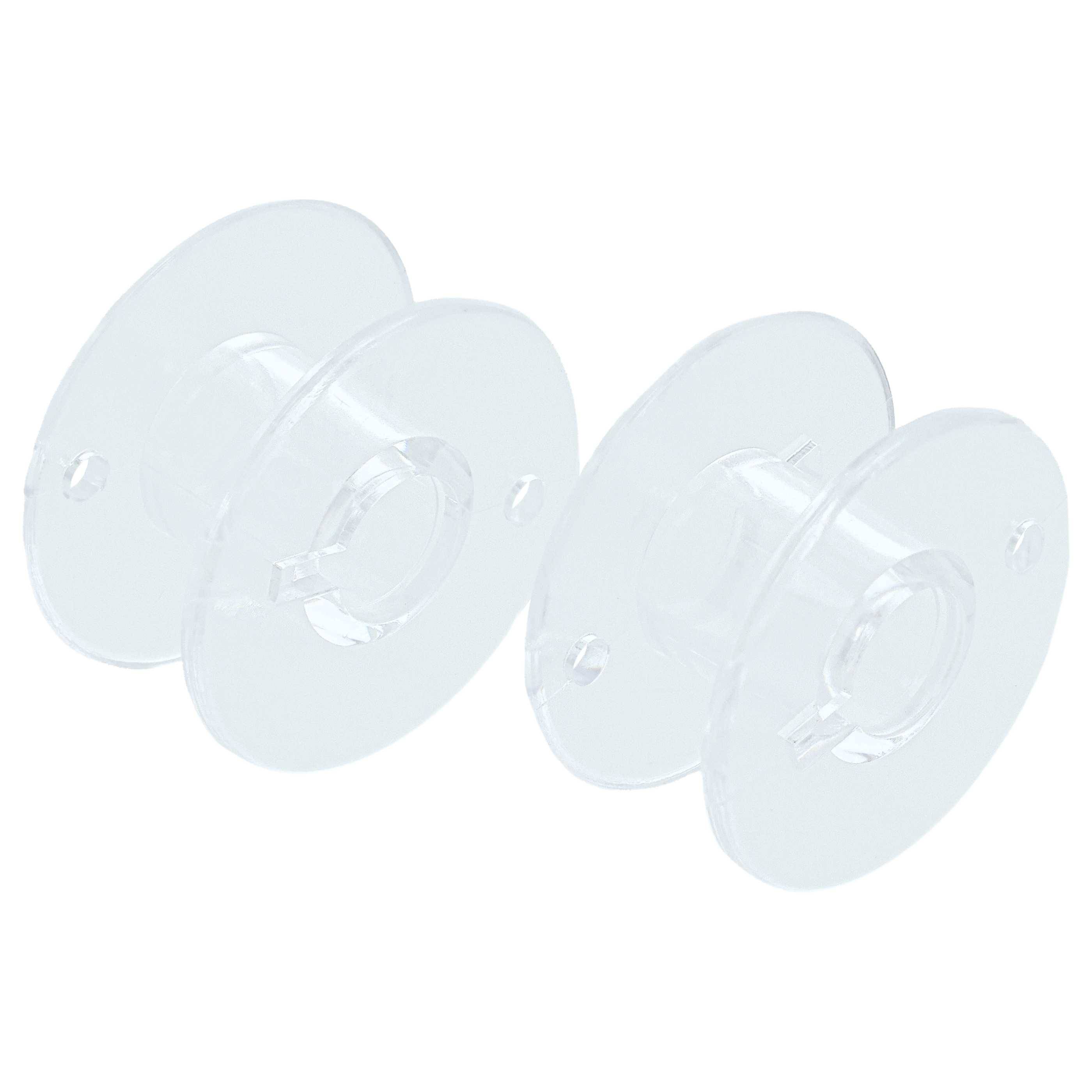 Zwei klare, leere Kunststoffspulen nebeneinander, verwendet zum Halten von Nähmaschinen-Garn.