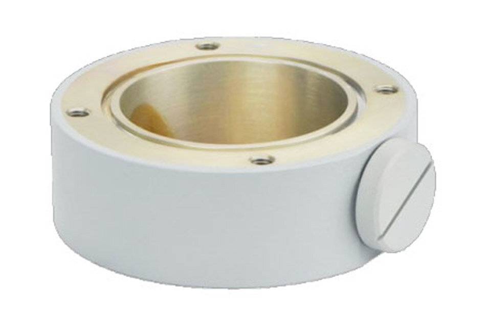 Weißes zylindrisches mechanisches Gehäuse mit messingausgekleideter Mittelöffnung, vier Schraubenlöcher oben und einer seitlichen Feststellschraube.