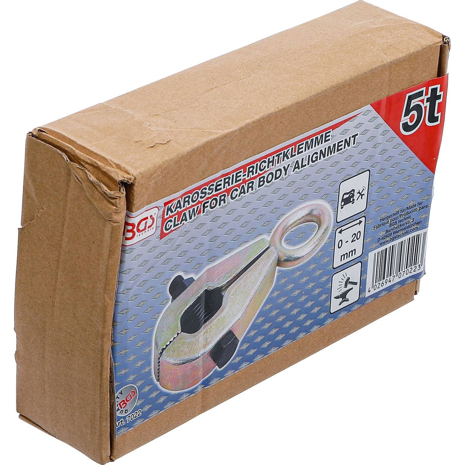 Eine Kartonschachtel, die ein Bild einer Metallklaue für die Karosserieausrichtung zeigt, mit der Markierung '5t'. Text enthält 'Klaue für Karosserieausrichtung'.