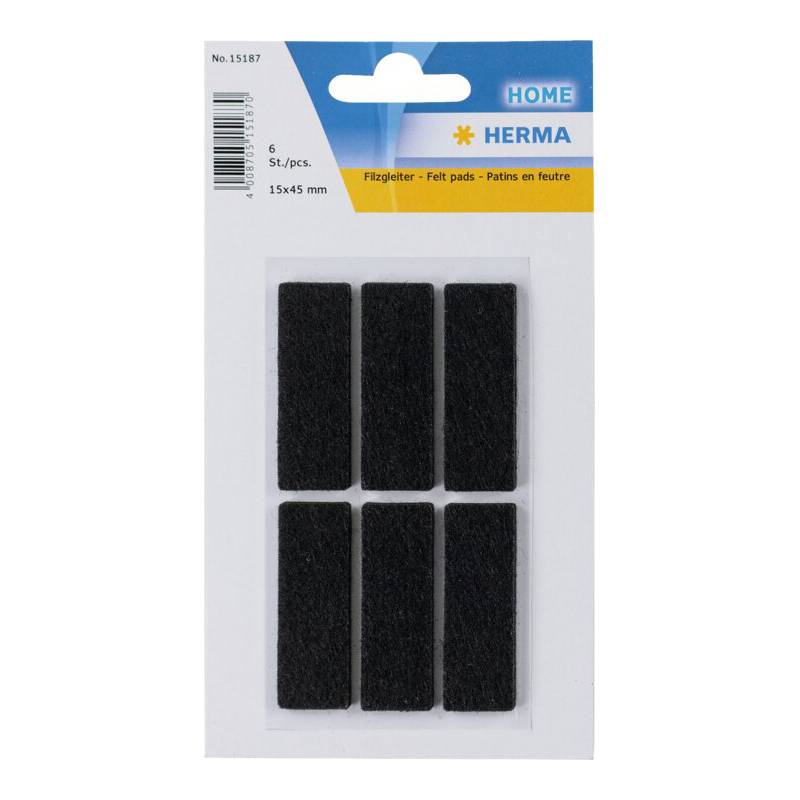 Packung mit sechs rechteckigen schwarzen Filzunterlagen, mit der Aufschrift 'HERMA HOME'. Zum Schutz von Oberflächen. Größe: 15x45 mm.