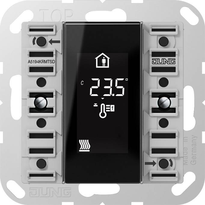 Ein digitales Thermostatdisplay zeigt das Hausicon, die Temperaturanzeige '23,5' und das Thermosensorsymbol, eingebaut in einen Metallrahmen.