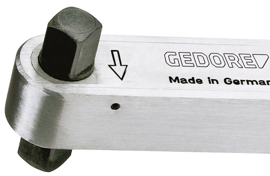 Nahaufnahme eines GEDORE-Metallwerkzeugs mit Vierkantantrieb und einem nach unten weisenden Pfeil, der die Einstellungs- oder Einsatzstelle markiert.