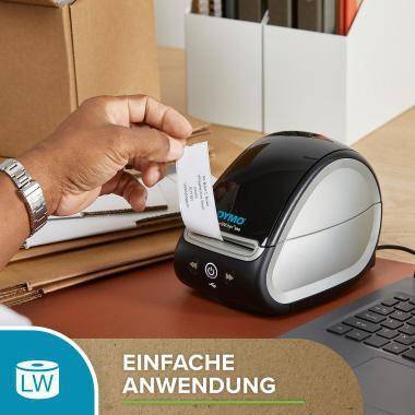 Die Hand führt ein Etikett in einen DYMO-Etikettendrucker neben einer Tastatur ein; der Text sagt „EINFACHE ANWENDUNG
