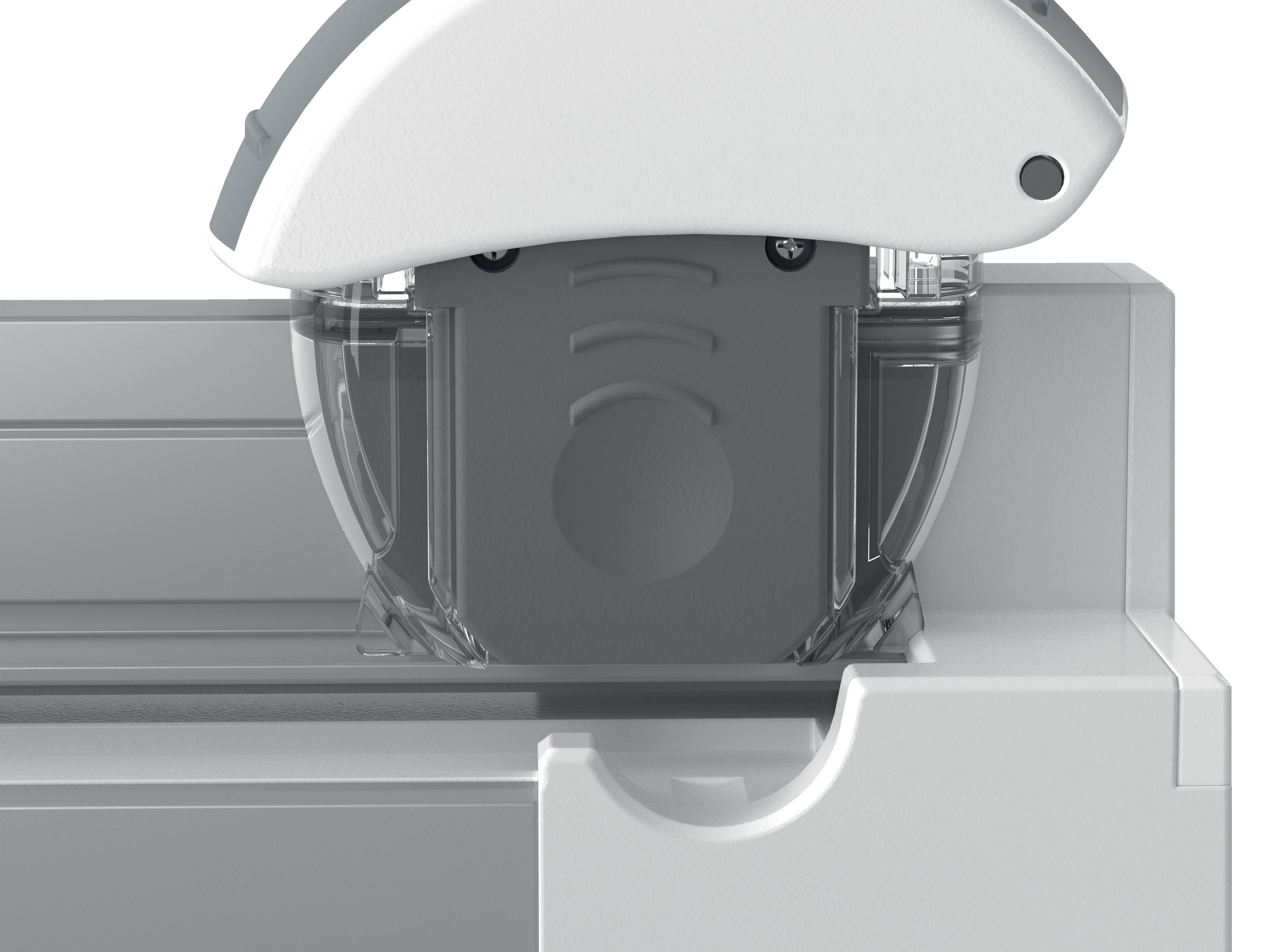Nahaufnahme eines Schneidewerkzeugs oder Druckkopfs eines 3D-Druckers mit Schutzabdeckung, montiert auf einer Schiene und über einer Arbeitsfläche positioniert.