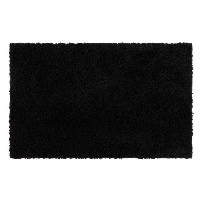 Ein rechteckiger schwarzer Hochflor-Teppich mit einer weichen, strukturierten Oberfläche.