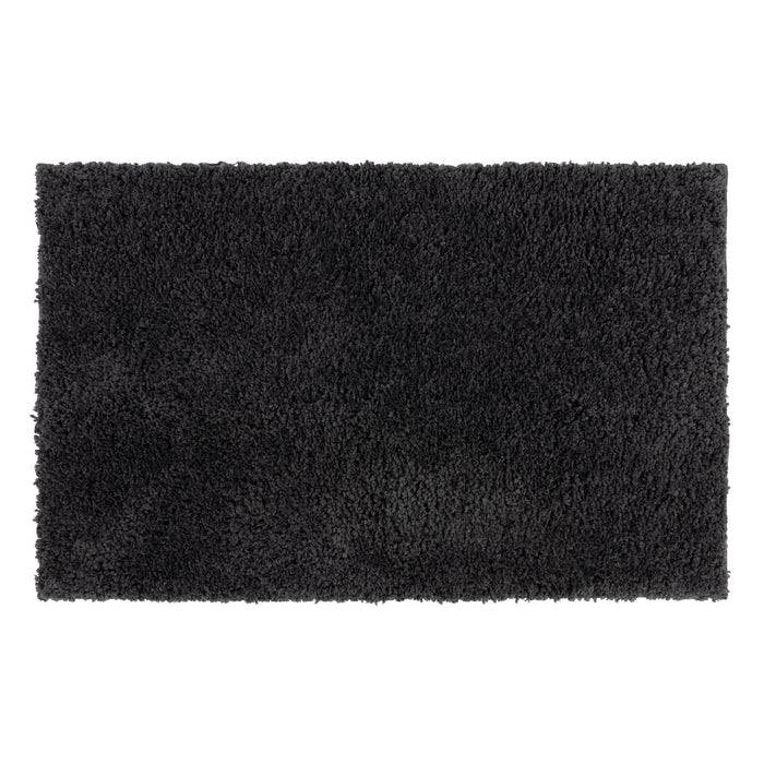 Ein rechteckiger, plüschiger schwarzer Teppich mit weicher, zottiger Textur füllt den Rahmen und zeigt eine einheitliche Farbe und Gestaltung.