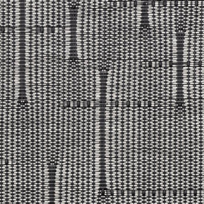 Eine Nahaufnahme eines strukturierten schwarz-weißen Gewebes mit einem Rastermuster und vertikalen Linien, das ein modernes, strukturiertes Design schafft.