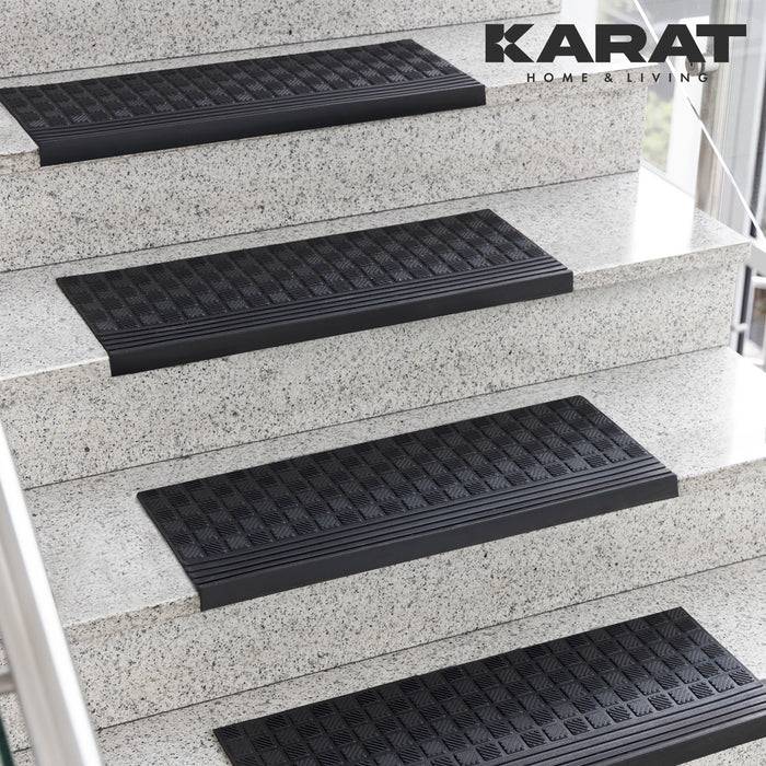 KARAT HOME & LIVING' Logo über schwarzen rutschfesten Matten auf einer weißen Granittreppenanlage.