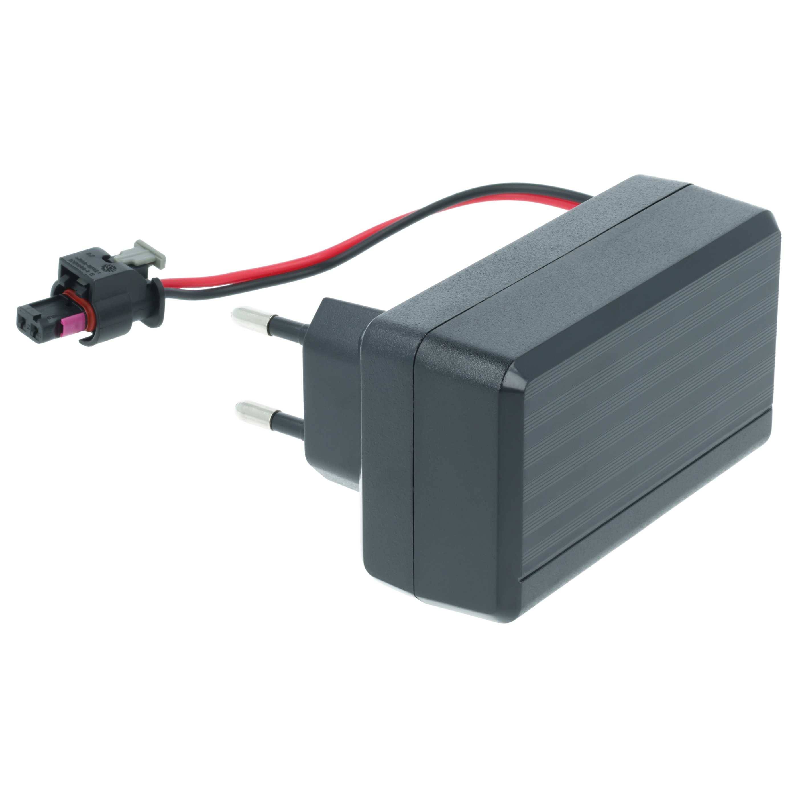 Ein schwarzer AC-DC-Adapter mit Steckstiften, verbunden mit einem roten und schwarzen Kabel, das in einem Kunststoffanschluss endet, konzipiert für elektronische Geräte.