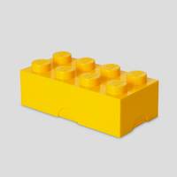 Gelber LEGO-ähnlicher Baustein auf einfachem hellgrauem Hintergrund.