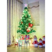 Dekorierter Weihnachtsbaum im Innenraum mit Lichtern, einer Baumspitze in Sternform, einer Geschenkbox-Verzierung und kleinen Rentier- und Schneemann-Dekorationen in der Nähe.