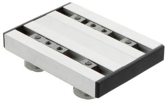 Drei metallische parallele Stangen, die auf einer rechteckigen Basis montiert sind und einen kleinen Industriemaschinenteil oder eine Klemmkomponente auf weißem Hintergrund bilden.