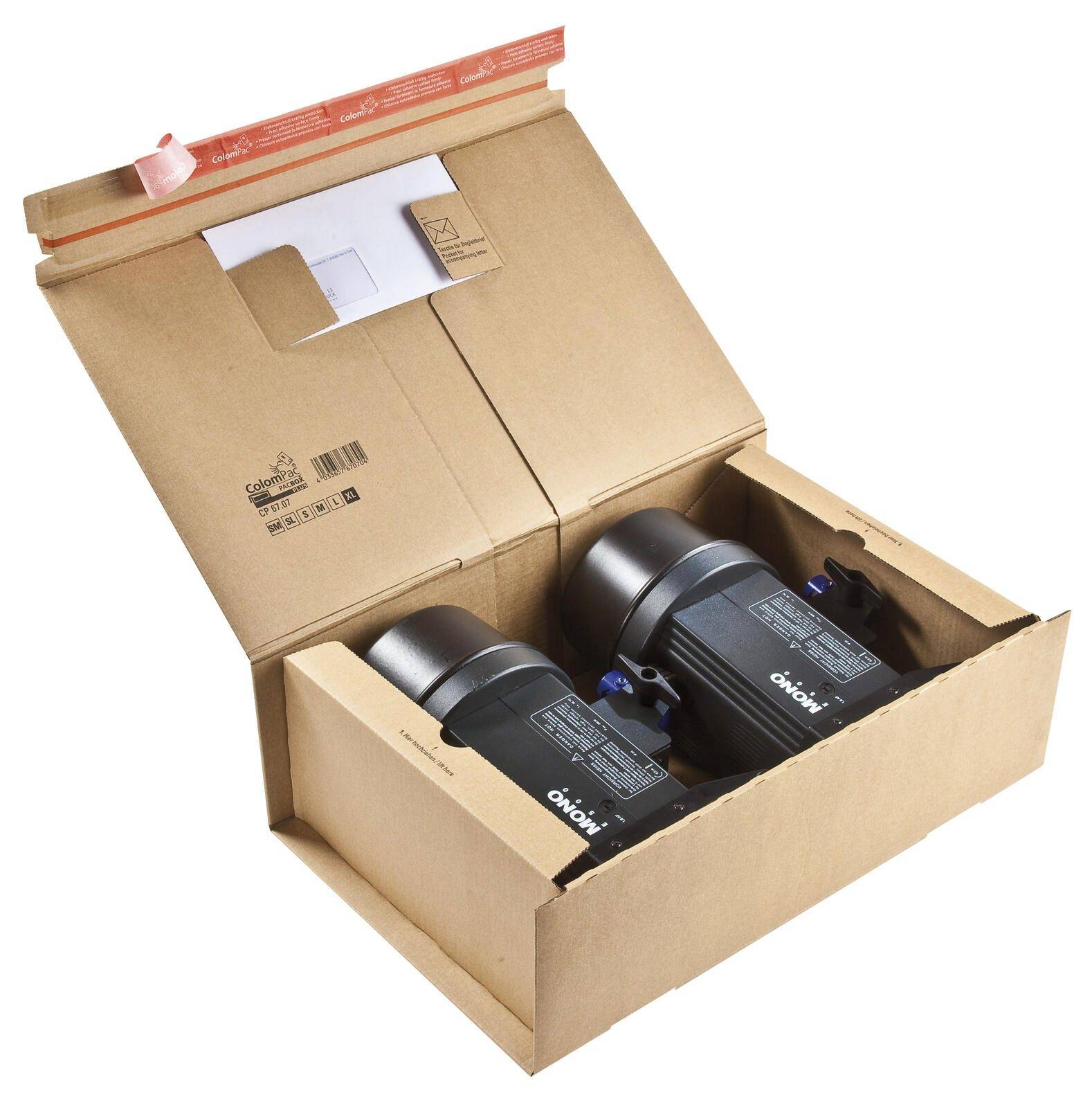 Offene Kartonversandbox mit zwei schwarzen zylindrischen Geräten in geformten Einsätzen verpackt, mit Unterlagen im Deckel.