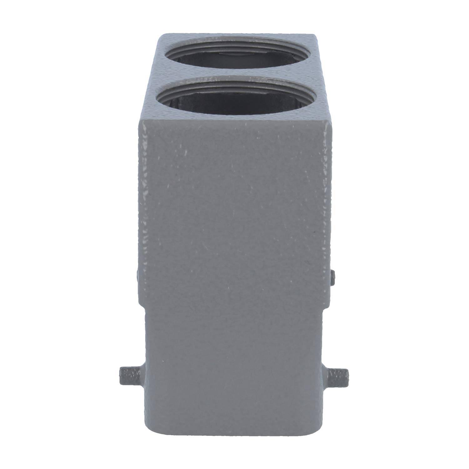 „Ein grauer, rechteckiger Metallblock mit zwei runden Vertiefungen auf der Oberseite, von der Seite betrachtet.