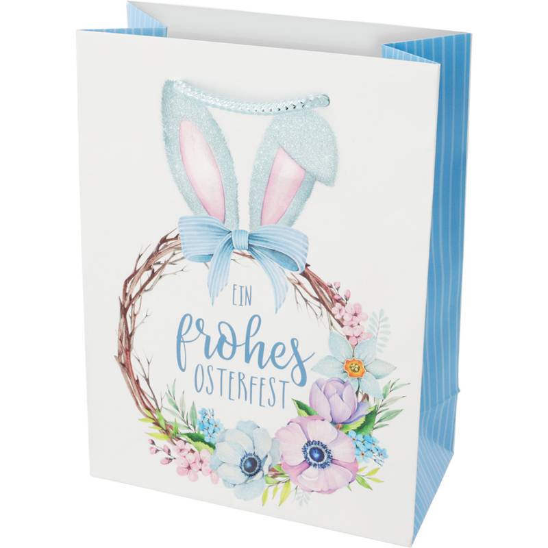 Eine Geschenktüte mit einem Blumenkranz und Hasenohren-Design, in deren Mitte der Text 'Ein frohes Osterfest' prangt, die Ostergrüße übermittelt.