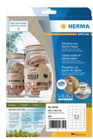 Verpackung für HERMA spezielle ablösbare Etiketten auf transparentem Papier, mit beschrifteten Gläsern als Beispiel und einer Vorschau von Barcode-/Etikettenblatt.