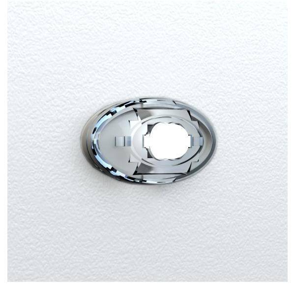 Eine Nahaufnahme eines ovalen Metalldübels an einer weißen strukturierten Wand, der für eine sichere Befestigung von Gegenständen entwickelt wurde.