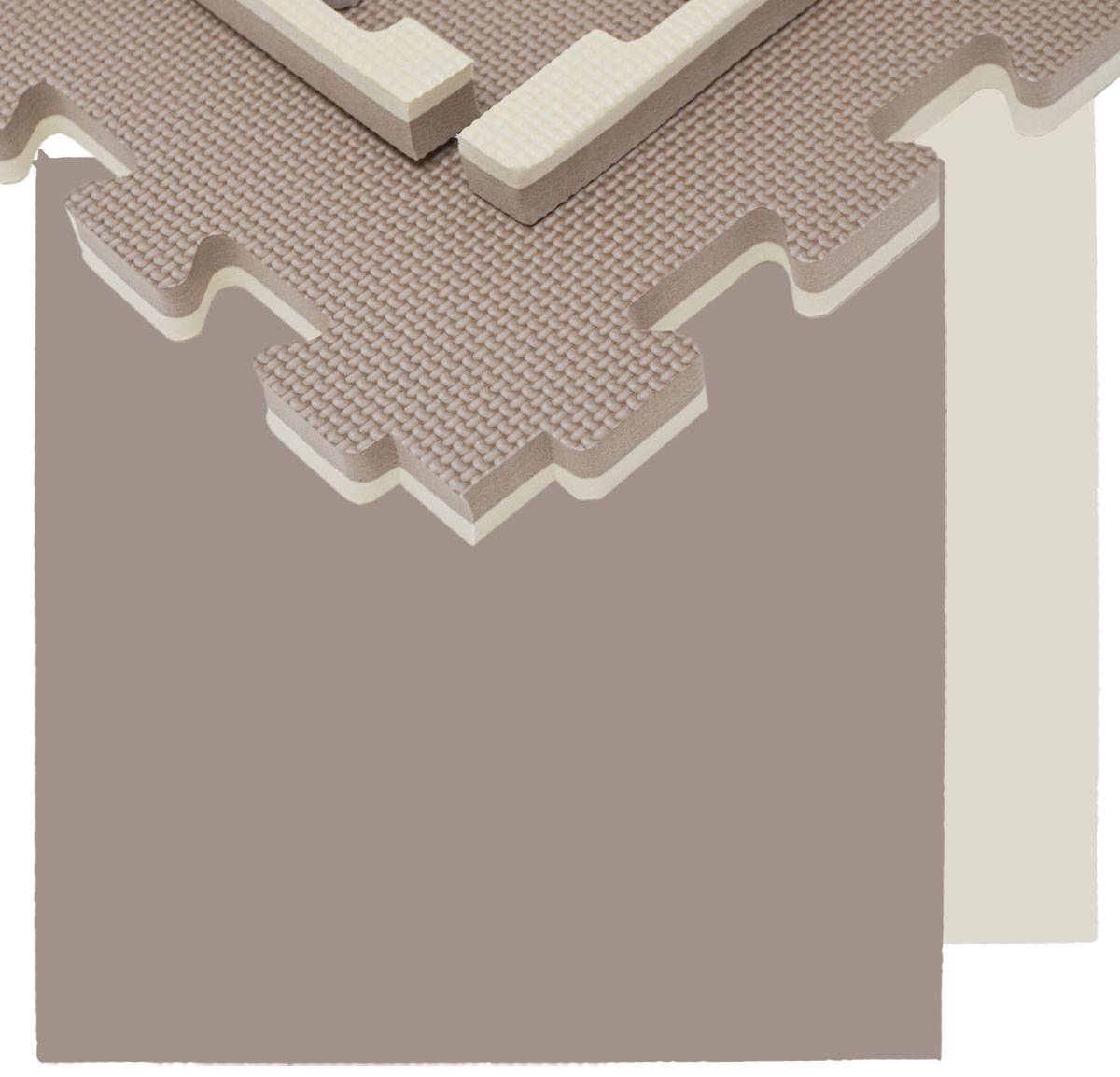 Nahaufnahme einer geschichteten Schaumstoff-Puzzlematte mit ineinandergreifenden Zickzackkanten, die eine beige strukturierte Oberfläche und Schaumstoffbasischichten zeigt.