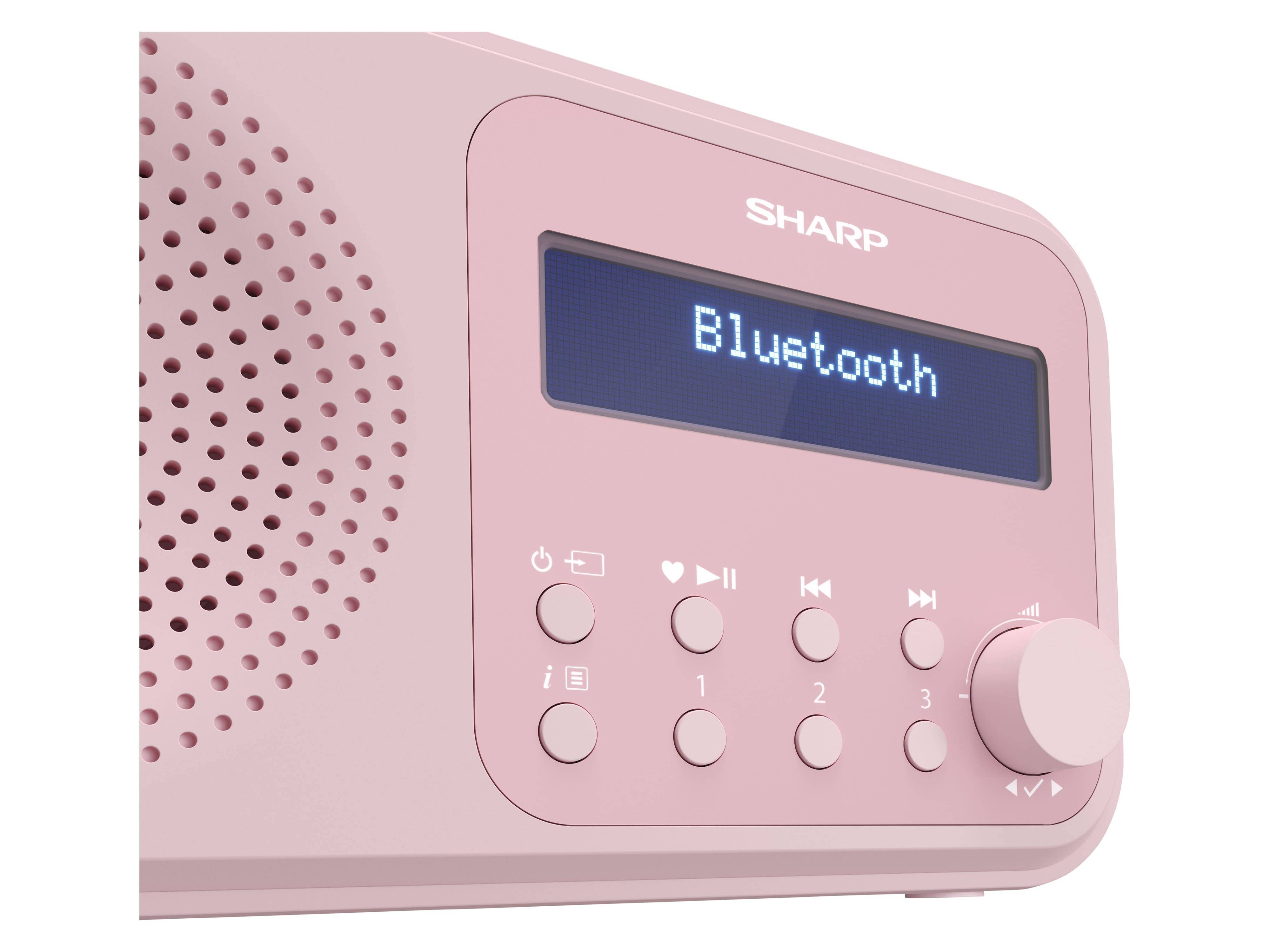 Ein rosa Sharp-Radio mit Bluetooth-Konnektivität, das auf einem digitalen Display 'Bluetooth' anzeigt. Es verfügt über Tasten für Ein/Aus, Wiedergabe, Pause und Lautstärke.