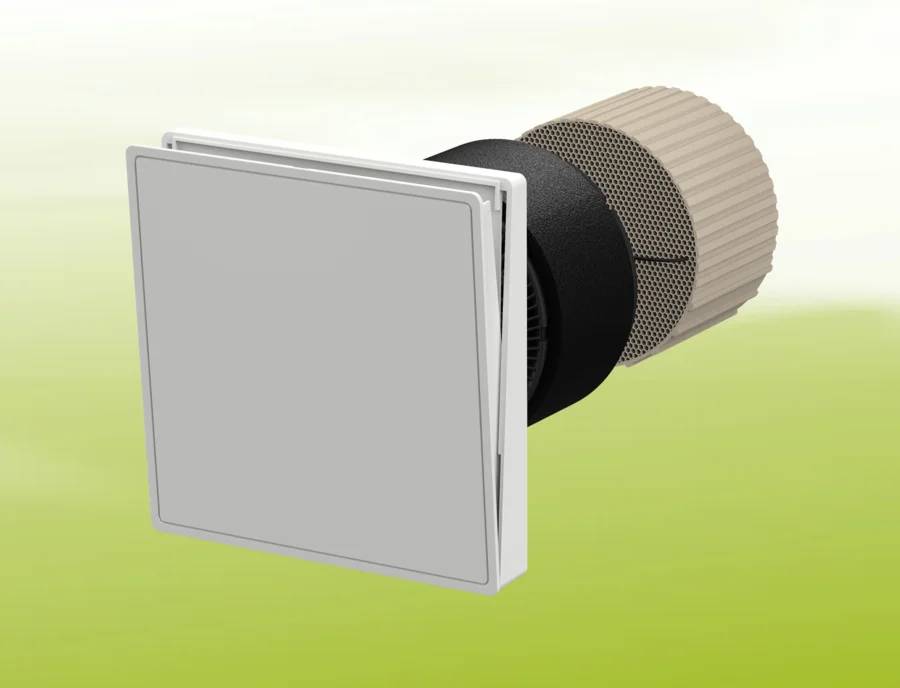 Ein an der Wand montiertes Luftlüftungsgitter oder Diffusor mit quadratischem Frontgitter und zylindrischem Hintergehäuse auf hellgrünem Hintergrund.