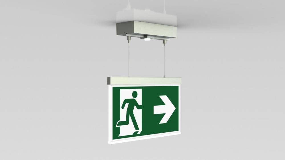 Hängendes Notausgangsschild mit grünem Hintergrund zeigt eine laufende Figur und einen nach rechts weisenden Pfeil, der die Richtung zur Evakuierung angibt.
