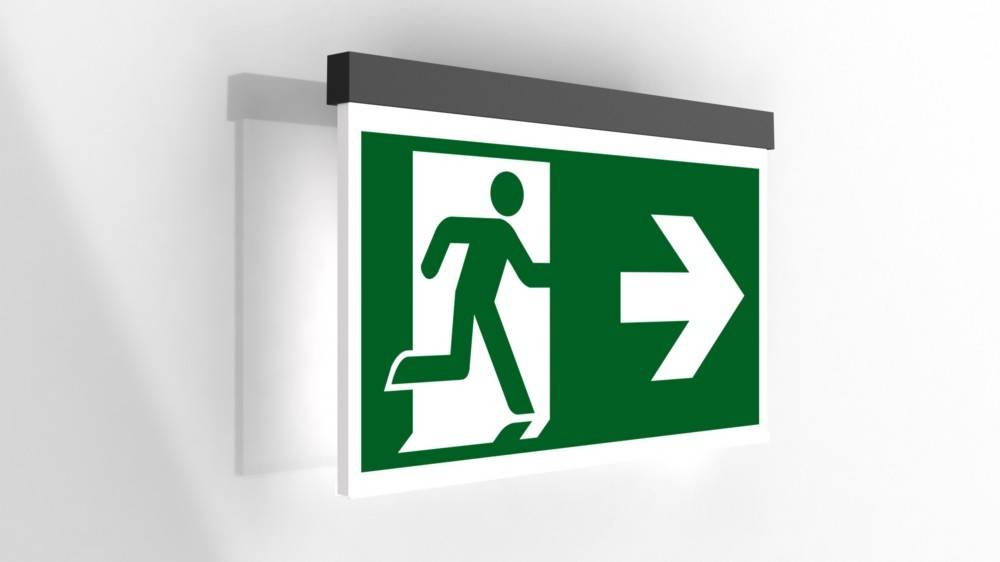 Grünes Notausgangsschild mit laufender Figur und nach rechts weisendem Pfeil, der die Richtung zum Ausgang anzeigt.