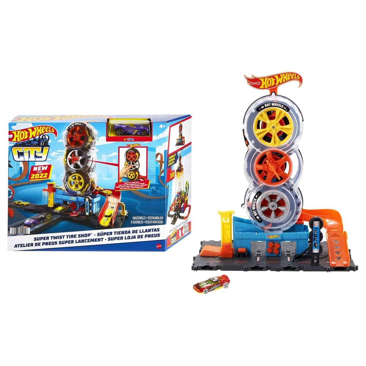 Hot Wheels City Super Twist Tire Shop Spielset mit gestapeltem Reifenturm und orangefarbener Trackplattform, gezeigt mit Produktbox und einem Spielzeugauto.