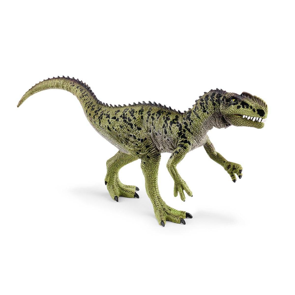 Grüne Spielzeug-Tyrannosaurus-rex-Figur, die auf weißem Hintergrund steht, in Profilansicht mit offenem Maul und erhobenenem Schwanz dargestellt.