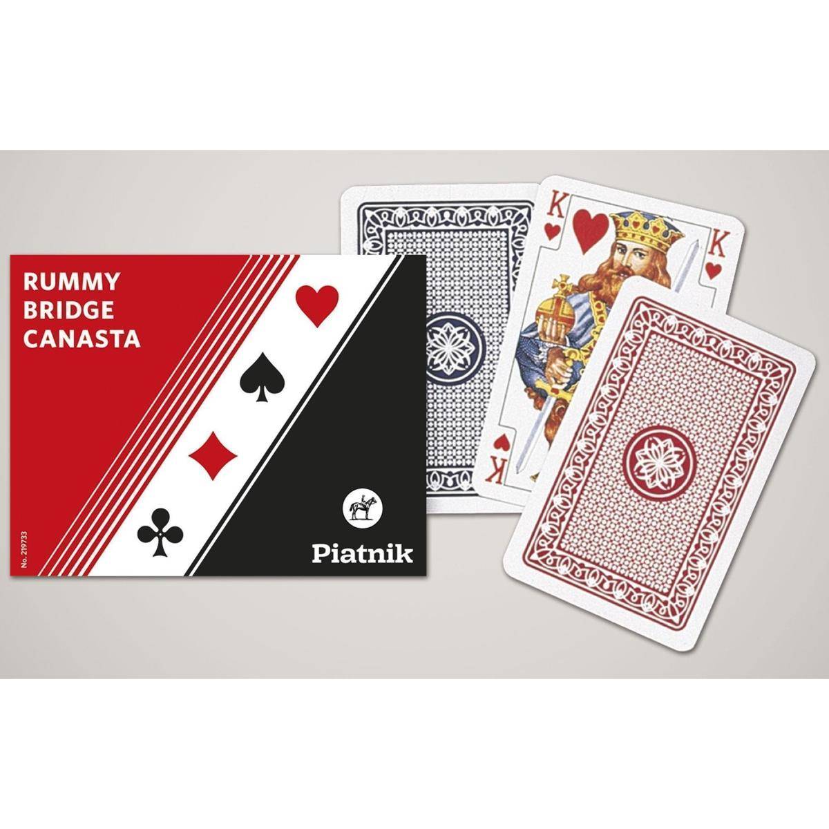 Piatnik Rommé Bridge Canasta Spielkartenstapel mit Box und mehreren aufgefächerten Karten, darunter Könige und gemusterte Kartenrückseiten.