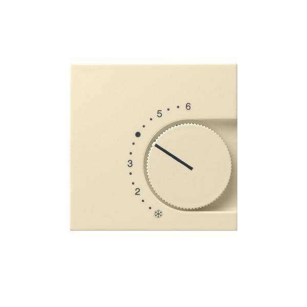Nahaufnahme eines beigen Thermostatdrehreglers mit Einstellungen von 2 bis 6 und einem Schneeflocken-Symbol; der Zeiger ist auf etwa 4 eingestellt.