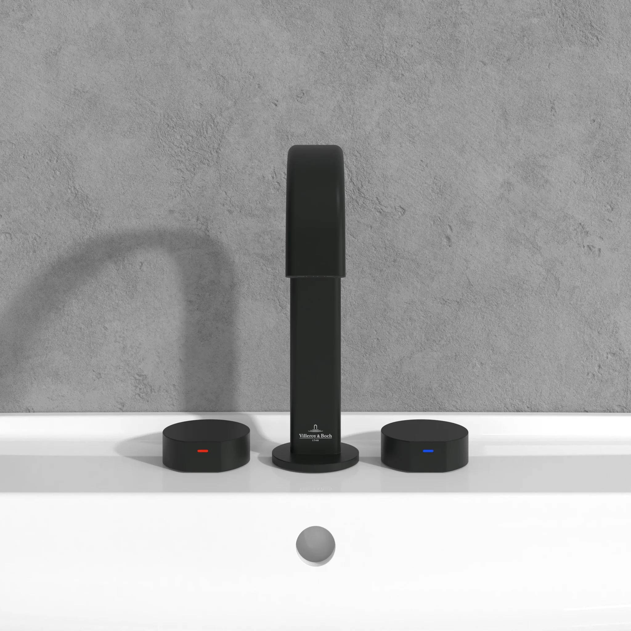 Schwarze Duschsäule mit zwei passenden Kontrollknöpfen auf einer weißen Ablage vor einer grauen Wand; rote und blaue Anzeigelichter zeigen die Heißwasser- und Kaltwasserregler an.