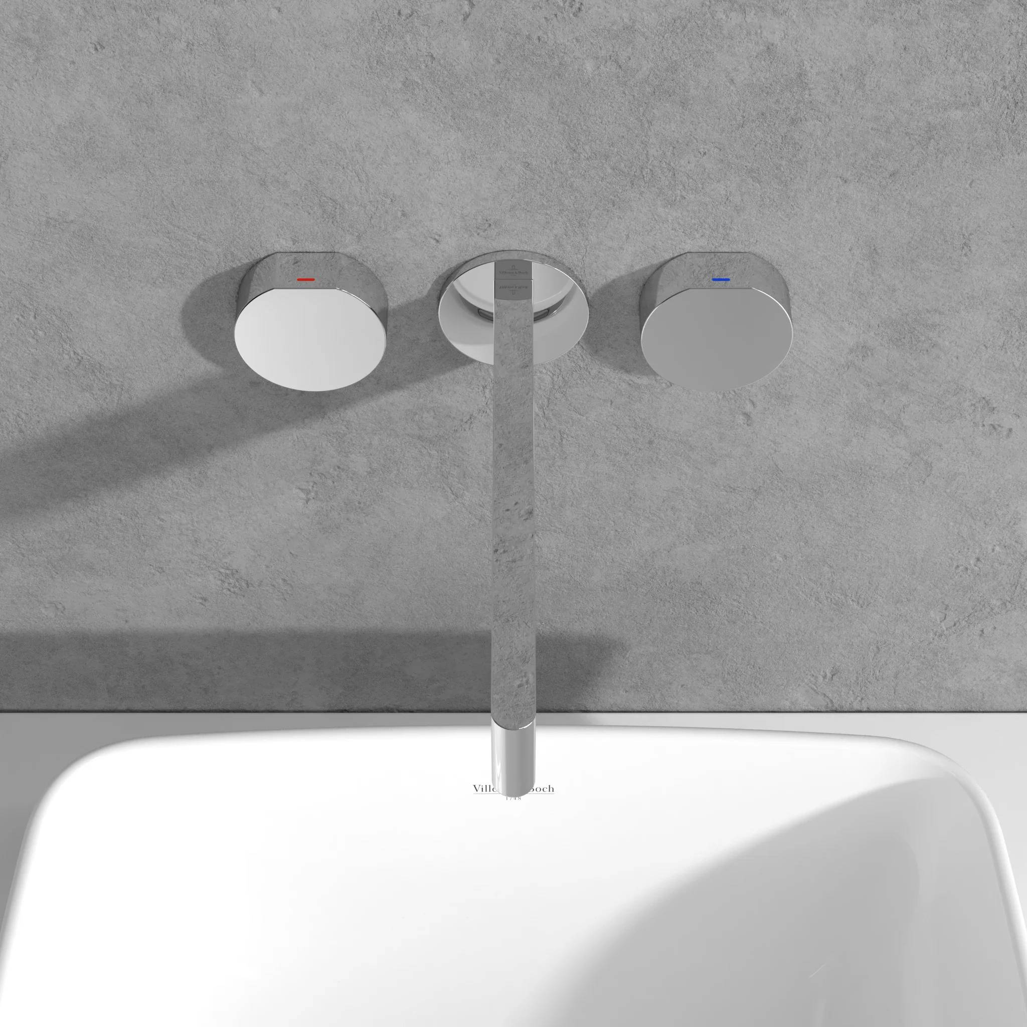 Moderner wandmontierter Badezimmerwasserhahn aus Chrom über einem weißen Waschbecken, mit separaten roten und blauen Temperaturmarkierungen auf den Griffen.