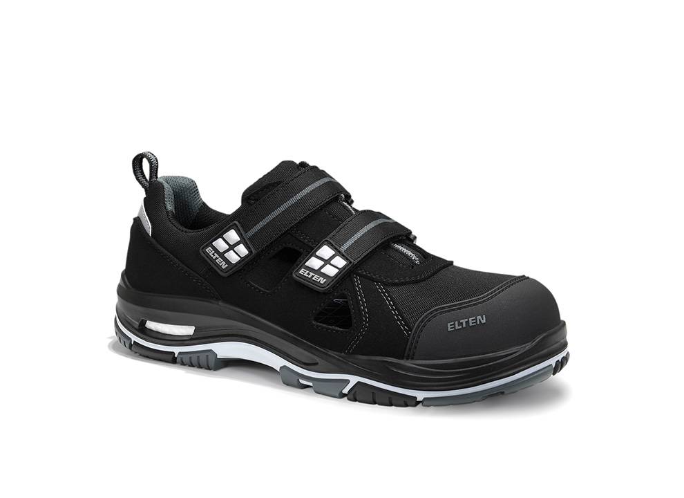 Ein schwarzer und grauer Sneaker mit Klettverschlüssen, beschriftet mit 'Elten', auf weißem Hintergrund. Der Schuh verfügt über eine Gummisohle und eine verstärkte Zehenpartie.