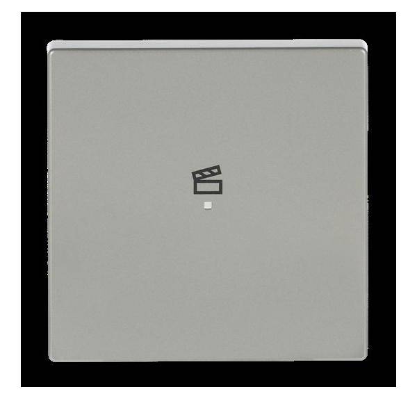 Eine quadratische Taste mit einem Filmklappe-Symbol, das eine Kino- oder videobezogene Funktion anzeigt, auf einem schlichten schwarzen Hintergrund.