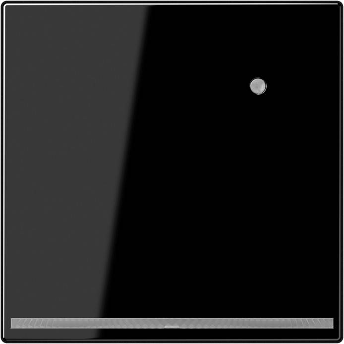 Ein schwarzes quadratisches Panel mit einem kleinen runden Knopf nahe der oberen rechten Ecke.